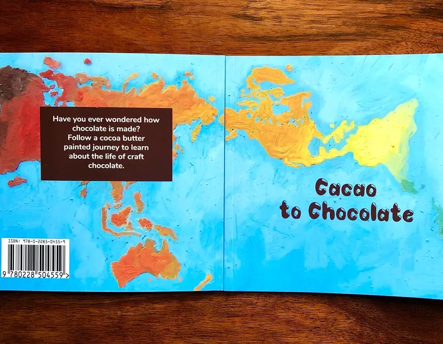 The book's full cover laid flat, showing the back-cover blurb inviting readers to follow a cocoa-butter painted journey through the life of craft chocolate.