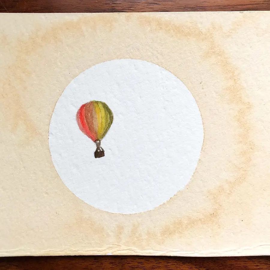 Watercolour and cocoa-ink painting of a hot-air balloon.