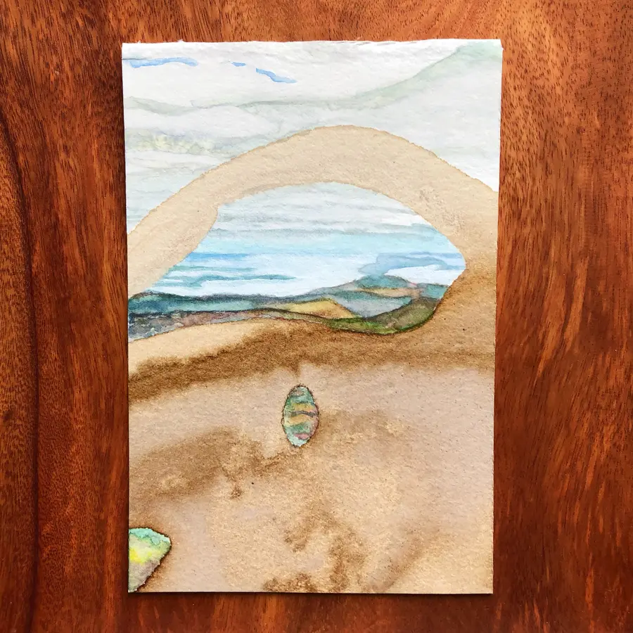 Watercolour and cocoa-ink painting of the ocean meeting the sky.